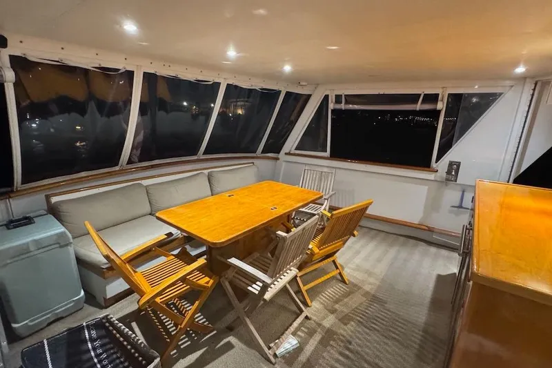 Slide: The Image of Luxurious interior of a 1974 Burger 67 Motor Yacht with elegant seating and dining area. - 9