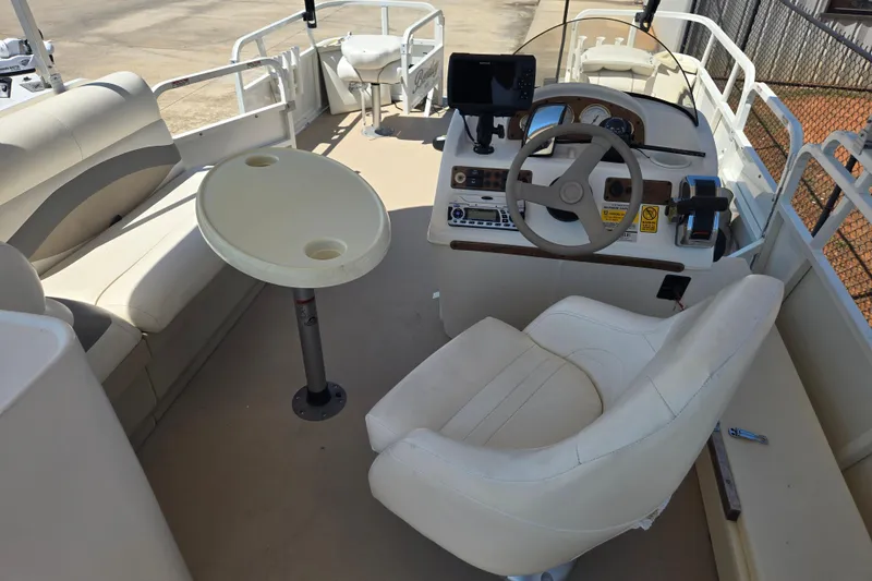 Slide: The Image of 2010 Bentley Pontoons 200 Fish interior with steering console and seating area. - 12