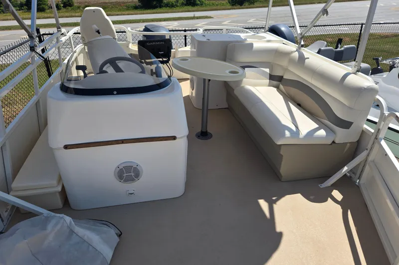 Slide: The Image of 2010 Bentley Pontoons 200 Fish interior with steering console and cushioned seating. - 16