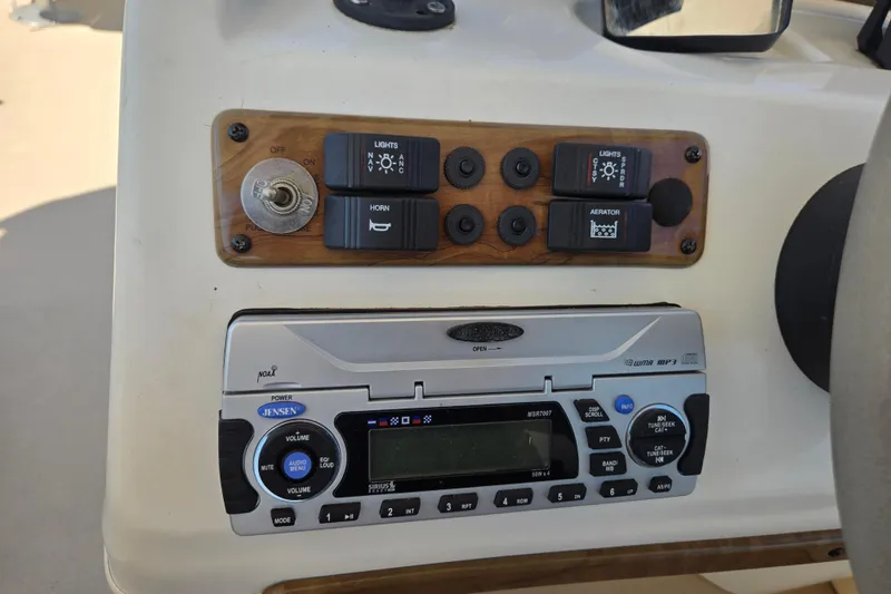 Slide: The Image of Control panel of a 2010 Bentley Pontoons 200 Fish with switches and Jensen stereo. - 7