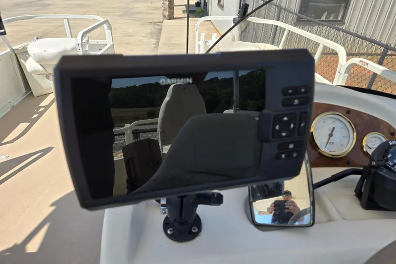 Slide: The Image of Garmin device on 2010 Bentley Pontoons 200 Fish dashboard with gauges and controls. - 8