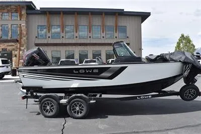 Slide: The Image of 2026 Lowe Fishing Machine 1875 boat on trailer, parked outdoors. - 11