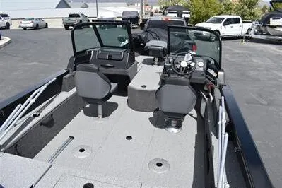 Slide: The Image of 2026 Lowe Fishing Machine 1875 boat interior with seating and steering console. - 17