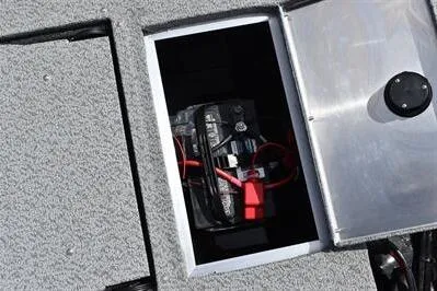 Slide: The Image of 2026 Lowe Fishing Machine 1875 battery compartment with secure storage. - 22