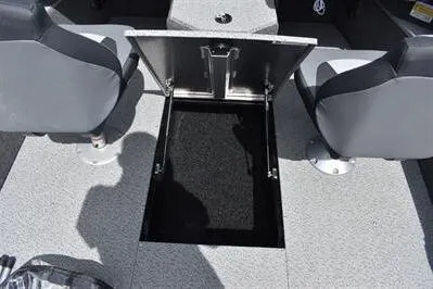Slide: The Image of 2026 Lowe Fishing Machine 1875 boat interior with open storage compartment and two seats. - 25