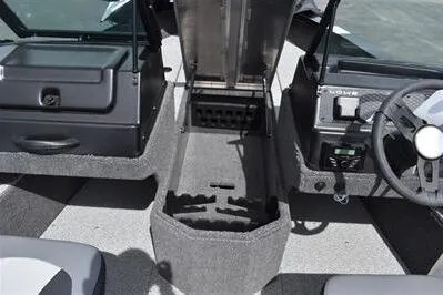 Slide: The Image of 2026 Lowe Fishing Machine 1875 interior with storage compartments and steering console. - 27