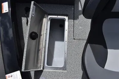 Slide: The Image of 2026 Lowe Fishing Machine 1875 boat interior with open storage compartment. - 29