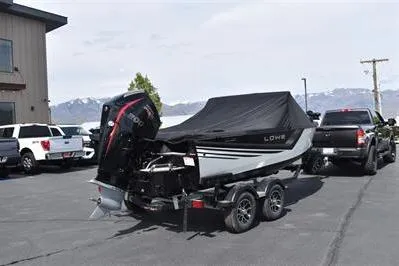 Slide: The Image of 2026 Lowe Fishing Machine 1875 boat on trailer, covered, parked outdoors. - 3