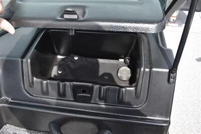 Slide: The Image of 2026 Lowe Fishing Machine 1875 storage compartment, open lid, black interior. - 33