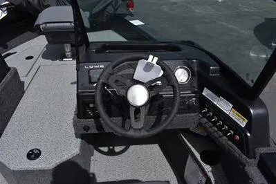 Slide: The Image of 2026 Lowe Fishing Machine 1875 dashboard with steering wheel and controls. - 35