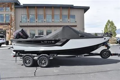 Slide: The Image of 2026 Lowe Fishing Machine 1875 boat on trailer, parked outdoors. - 4