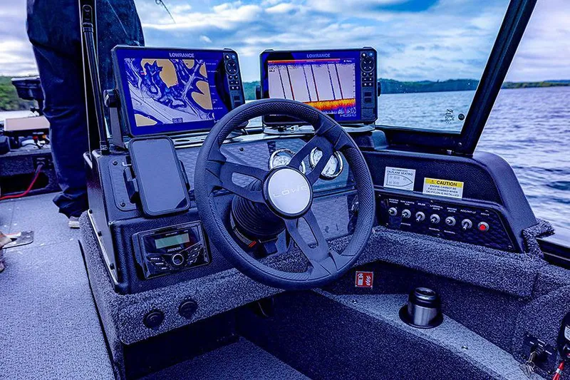 Slide: The Image of Manufacturer Provided Image: 2025 Lowe Fishing Machine 1875 dashboard with advanced navigation and sonar displays on a lake. - 45