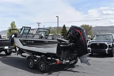 Slide: The Image of 2026 Lowe Fishing Machine 1875 boat on trailer, parked outdoors. - 9