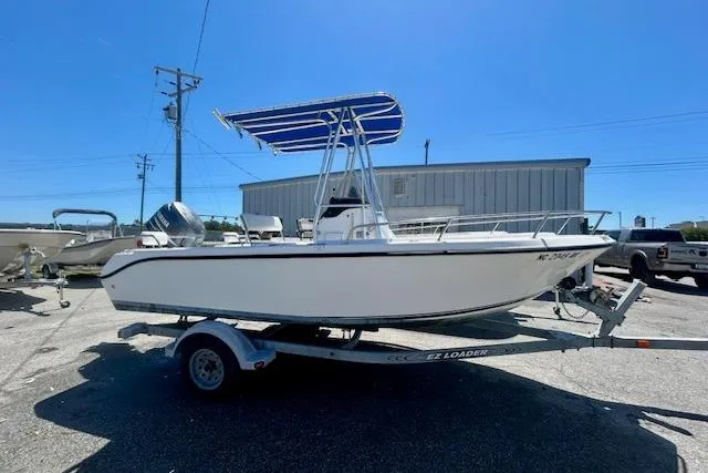 The Image of 2007 Century 1801 Center Console boat on trailer, parked outdoors under clear blue sky. - 0