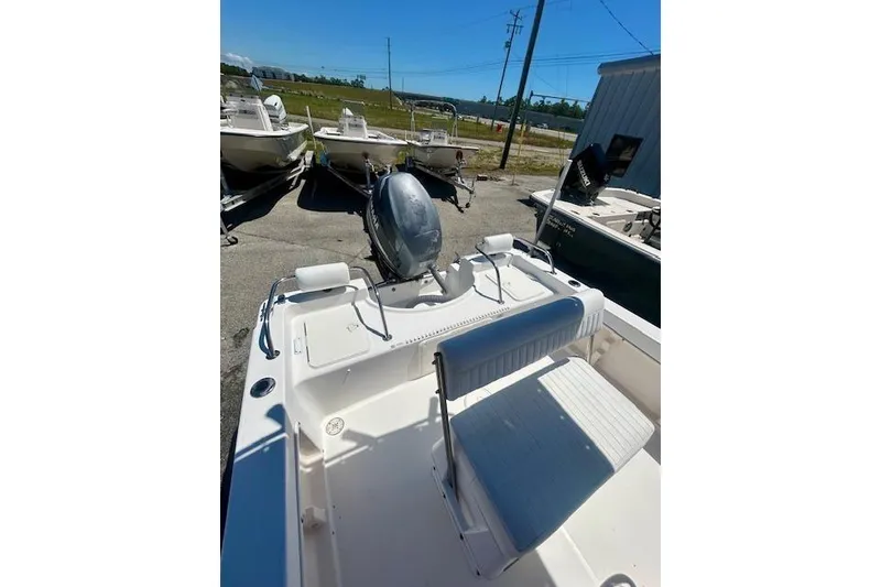 Slide: The Image of 2007 Century 1801 Center Console boat with seating and outboard motor in a marina setting. - 13