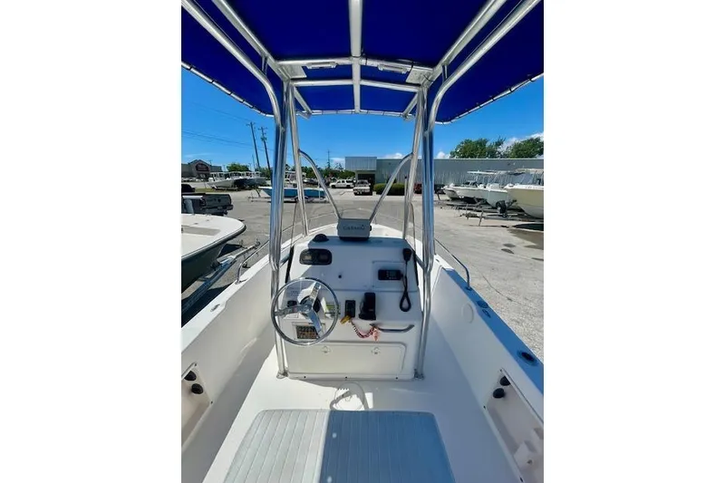 Slide: The Image of 2007 Century 1801 Center Console boat with blue canopy, parked in a marina. - 14