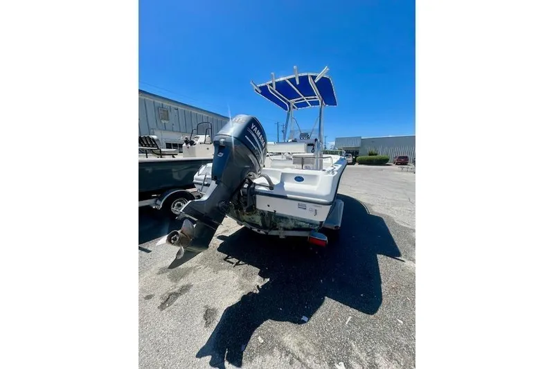 Slide: The Image of 2007 Century 1801 Center Console boat with Yamaha outboard motor, parked outdoors. - 3