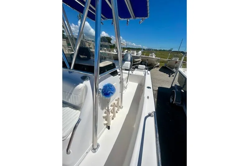 Slide: The Image of 2007 Century 1801 Center Console boat with blue canopy, docked under clear skies. - 5