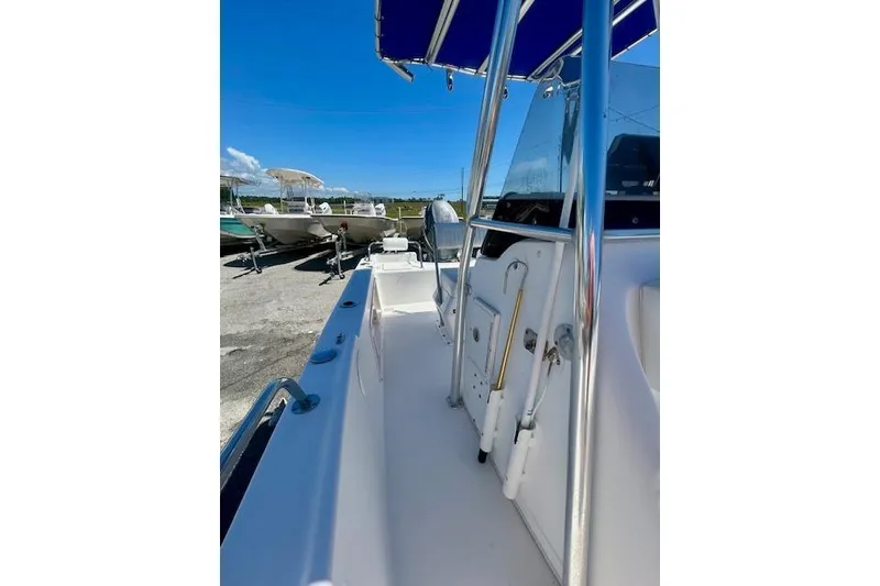 Slide: The Image of 2007 Century 1801 Center Console boat with blue canopy, docked outdoors. - 6