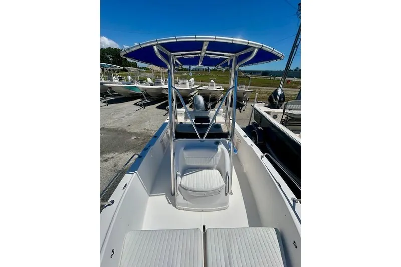 Slide: The Image of 2007 Century 1801 Center Console boat with blue canopy, docked outdoors. - 7