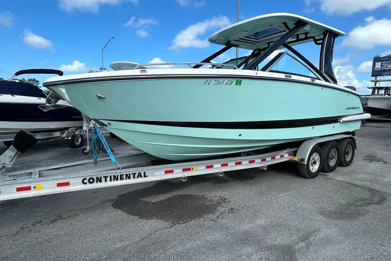 The Image of 2023 Chaparral 280 OSX boat on a Continental trailer, parked outdoors. - 1