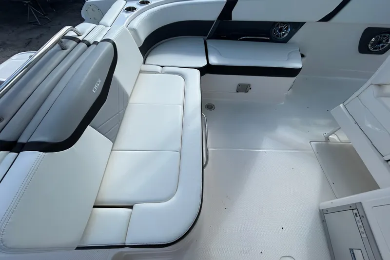 Slide: The Image of 2023 Chaparral 280 OSX boat interior with white seating and modern design. - 10