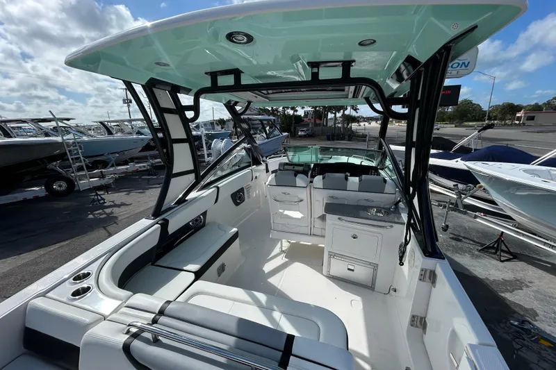 Slide: The Image of 2023 Chaparral 280 OSX boat interior with seating and helm, showcasing modern design. - 11
