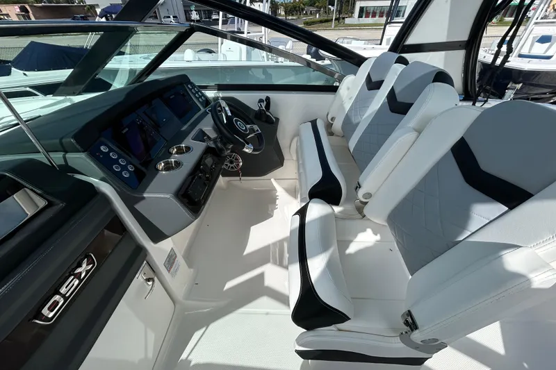 Slide: The Image of 2023 Chaparral 280 OSX boat interior with modern dashboard and seating. - 14