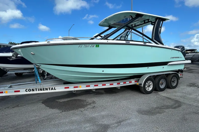 Slide: The Image of 2023 Chaparral 280 OSX boat on a trailer under a blue sky. - 3