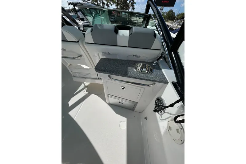 Slide: The Image of 2023 Chaparral 280 OSX boat interior with sink and seating area. - 7