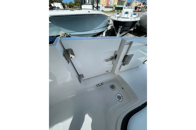 Slide: The Image of 2023 Chaparral 280 OSX boat interior with open hatch and drainage system. - 8
