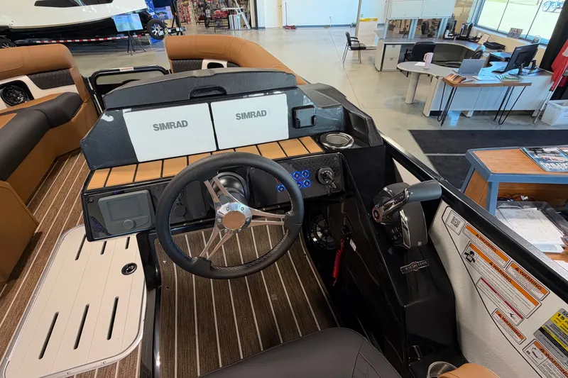 Slide: The Image of Interior view of 2027 Premier 230 Solaris RF - CL boat dashboard with Simrad displays. - 15