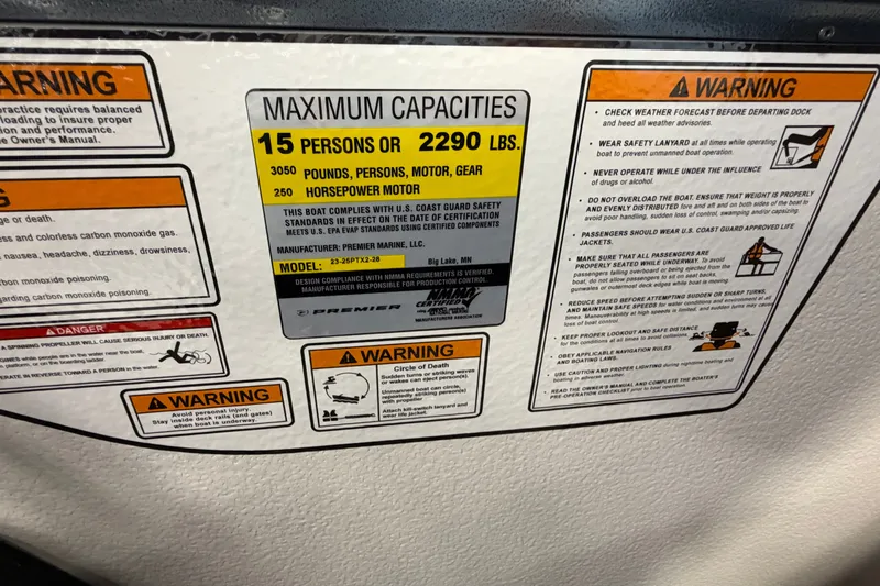 Slide: The Image of Warning labels on Premier 230 Solaris RF - CL boat, 2027 model, detailing capacity and safety instructions. - 23