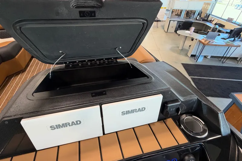Slide: The Image of Open storage compartment on 2027 Premier 230 Solaris RF - CL boat with Simrad electronics. - 16