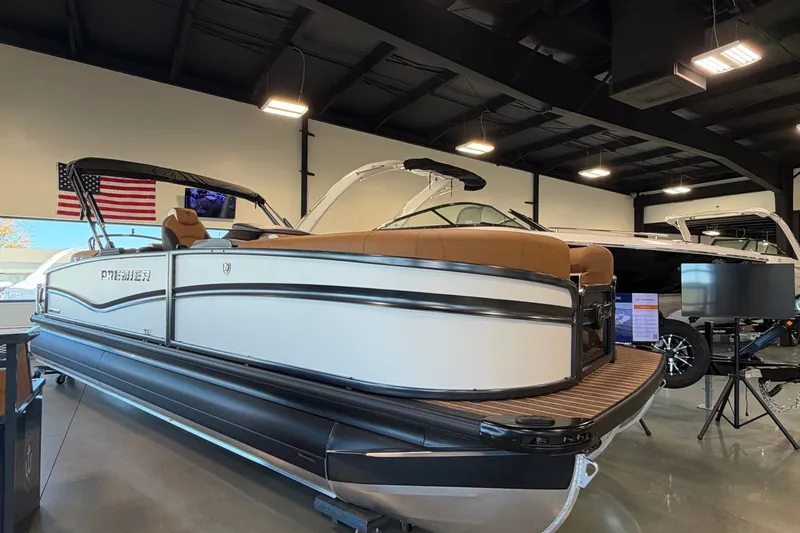 Slide: The Image of 2027 Premier 230 Solaris RF - CL pontoon boat displayed in a showroom. - 1