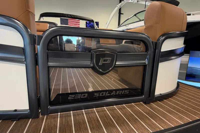Slide: The Image of 2027 Premier 230 Solaris RF-CL boat interior with logo and American flag. - 4