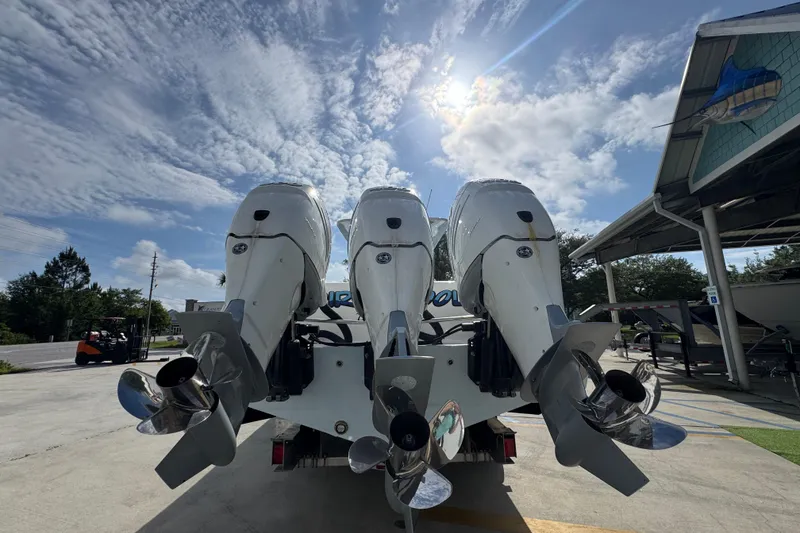 Slide: The Image of 2017 Invincible 39 Open Fisherman boat with triple outboard engines under a sunny sky. - 13