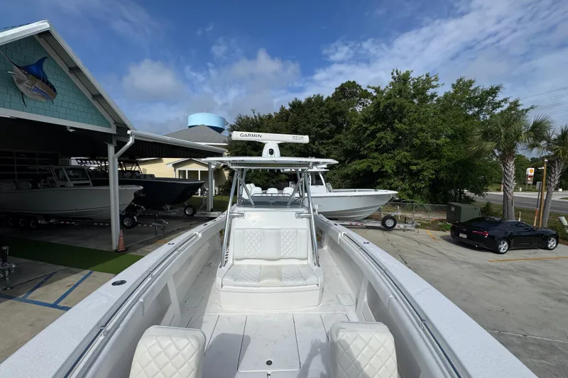Slide: The Image of 2017 Invincible 39 Open Fisherman boat docked at a marina under a clear sky. - 19