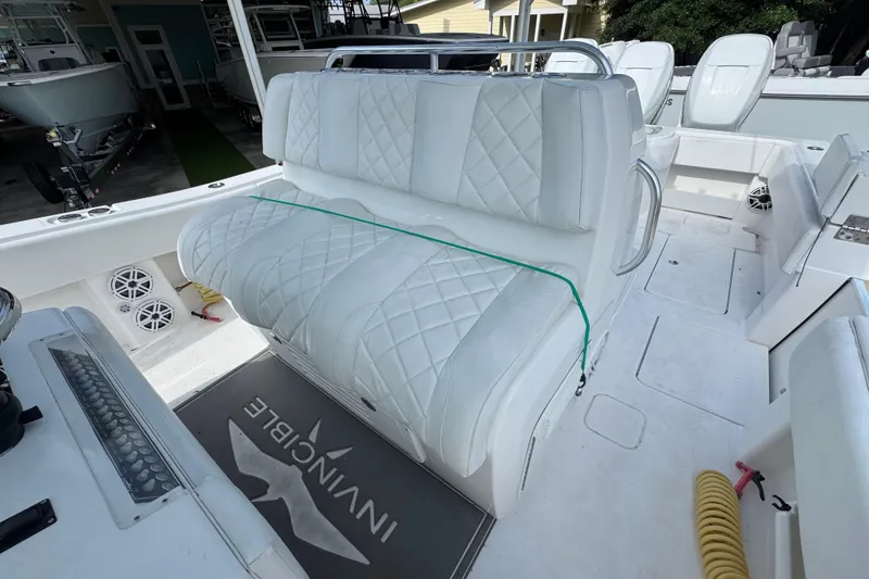 Slide: The Image of 2017 Invincible 39 Open Fisherman boat with white quilted seating and branded floor mat. - 22