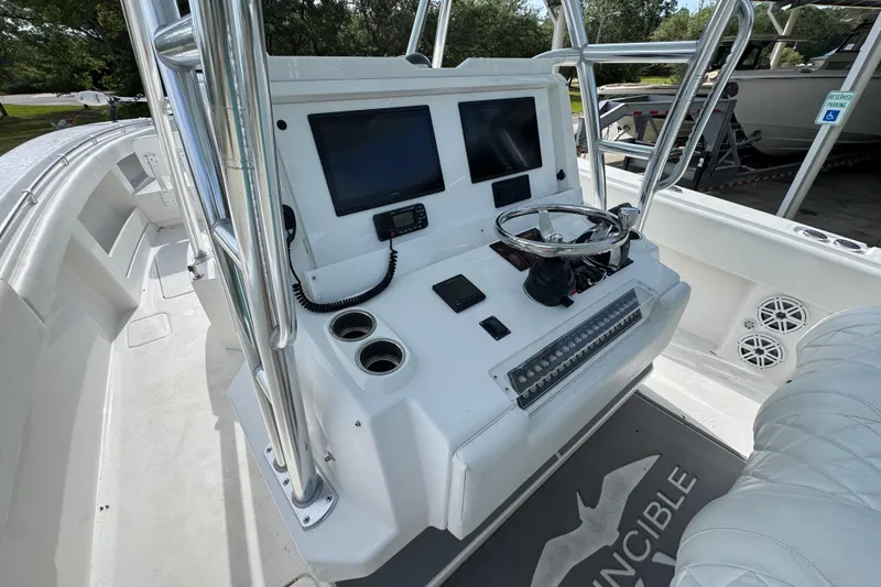 Slide: The Image of 2017 Invincible 39 Open Fisherman boat console with dual screens and steering wheel. - 23