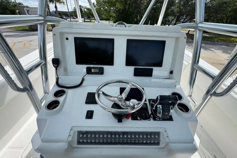 Slide: The Image of 2017 Invincible 39 Open Fisherman boat console with dual screens and steering wheel. - 24