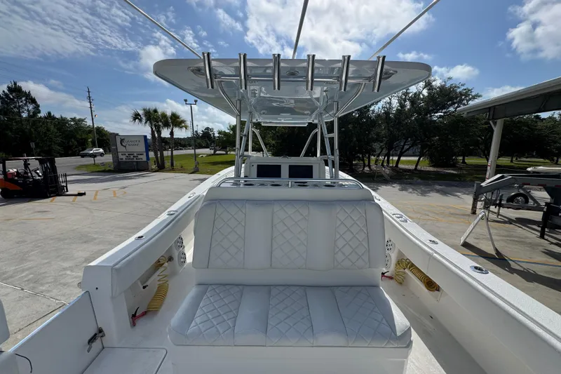 Slide: The Image of 2017 Invincible 39 Open Fisherman boat with white seating and rod holders, parked outdoors. - 27