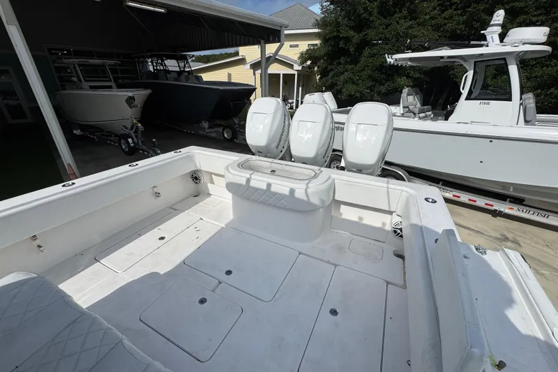 Slide: The Image of 2017 Invincible 39 Open Fisherman boat with triple engines, docked near other boats. - 29