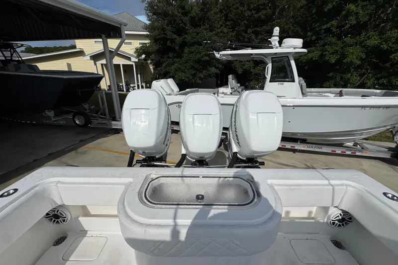 Slide: The Image of 2017 Invincible 39 Open Fisherman with triple outboard engines in a marina setting. - 30
