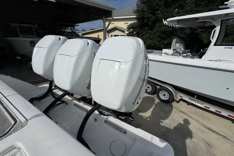 Slide: The Image of Triple outboard engines on a 2017 Invincible 39 Open Fisherman boat in a marina. - 31