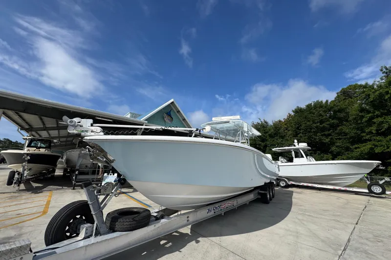 Slide: The Image of 2017 Invincible 39 Open Fisherman boat on trailer under clear blue sky. - 4