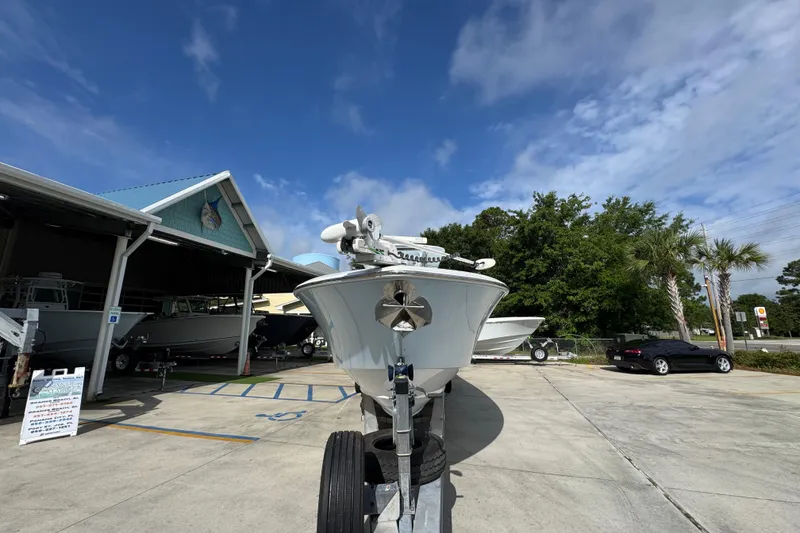 Slide: The Image of 2017 Invincible 39 Open Fisherman boat on trailer at marina under blue sky. - 6