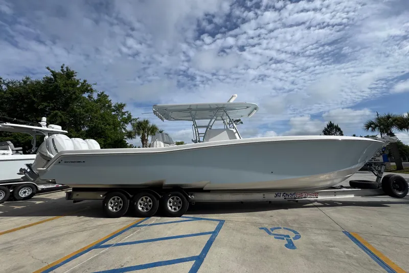 Slide: The Image of 2017 Invincible 39 Open Fisherman boat on trailer under a partly cloudy sky. - 9
