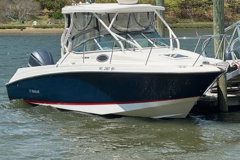 The Image of 2016 Wellcraft 252 Coastal boat docked on a sunny day, featuring sleek design and modern amenities. - 0