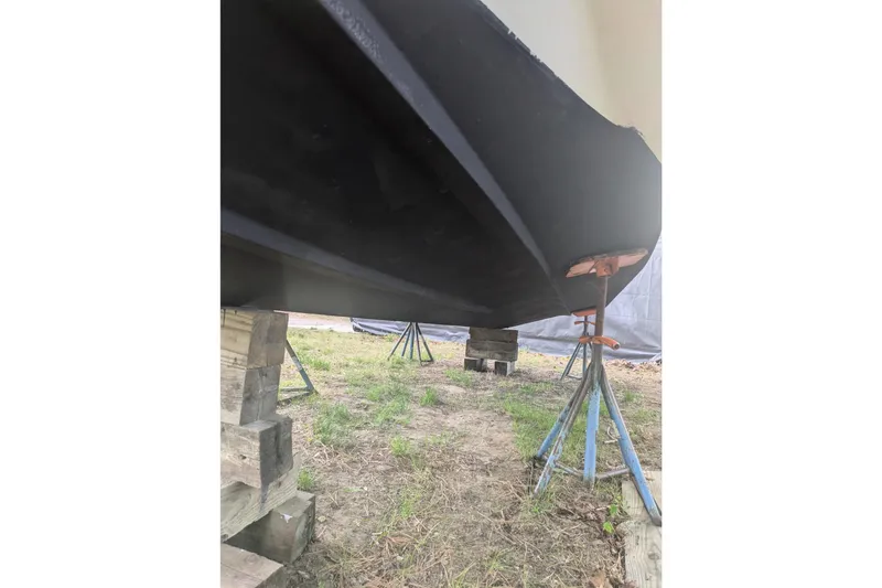 Slide: The Image of 2016 Wellcraft 252 Coastal boat hull on stands, viewed from below. - 10